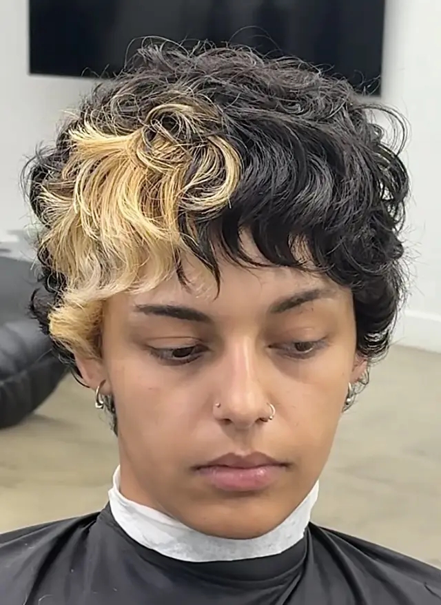 Curly textured cut with blonde highlight by Nathan Quizon